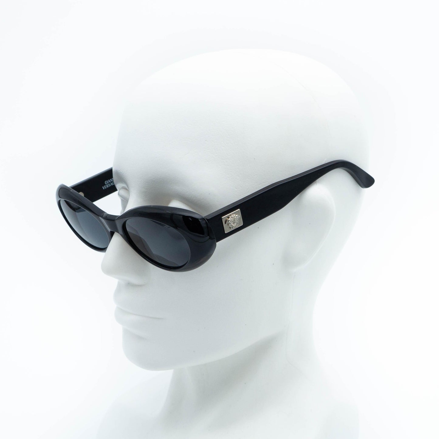 Versace black oval sunglasses on mannequin