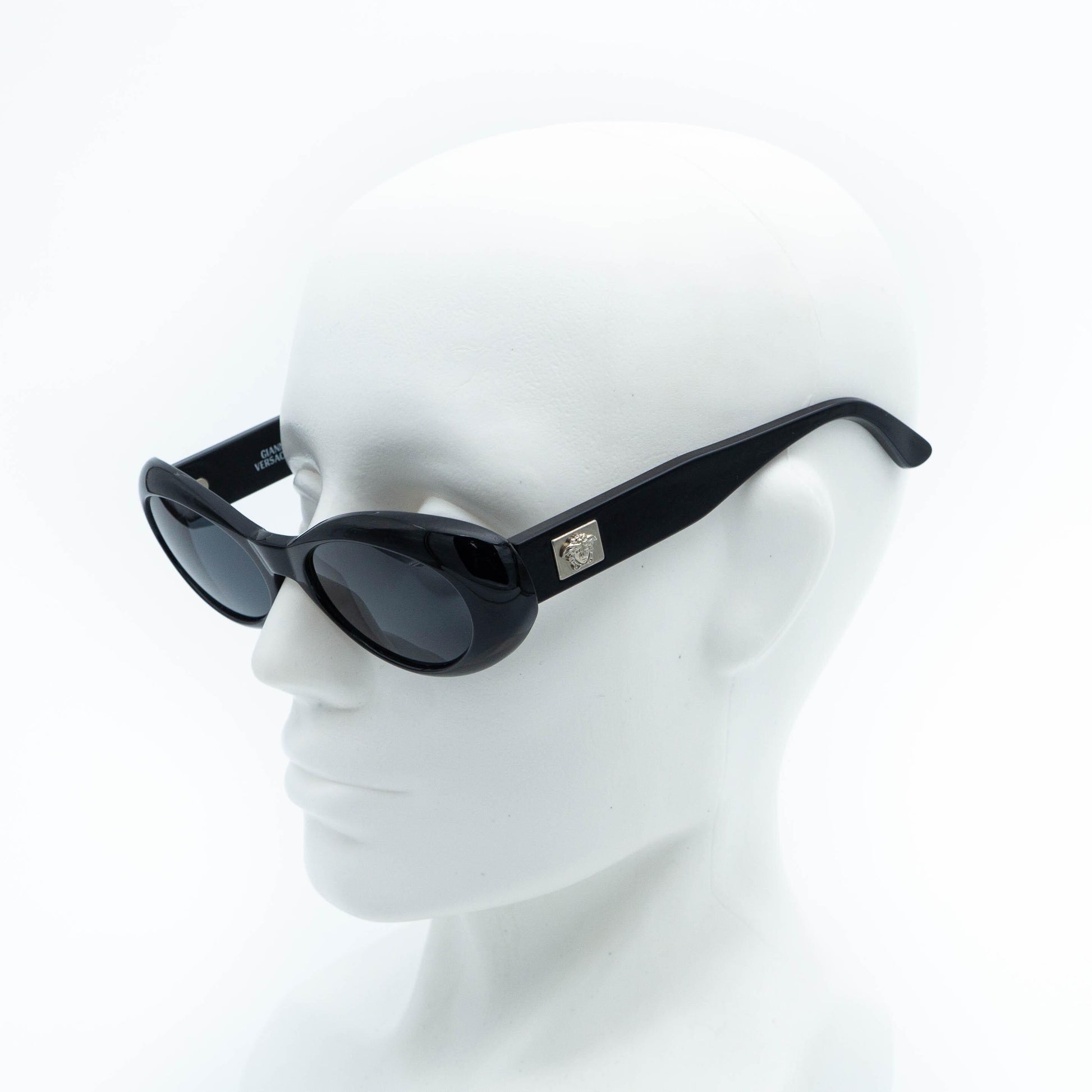 Versace black oval sunglasses on mannequin