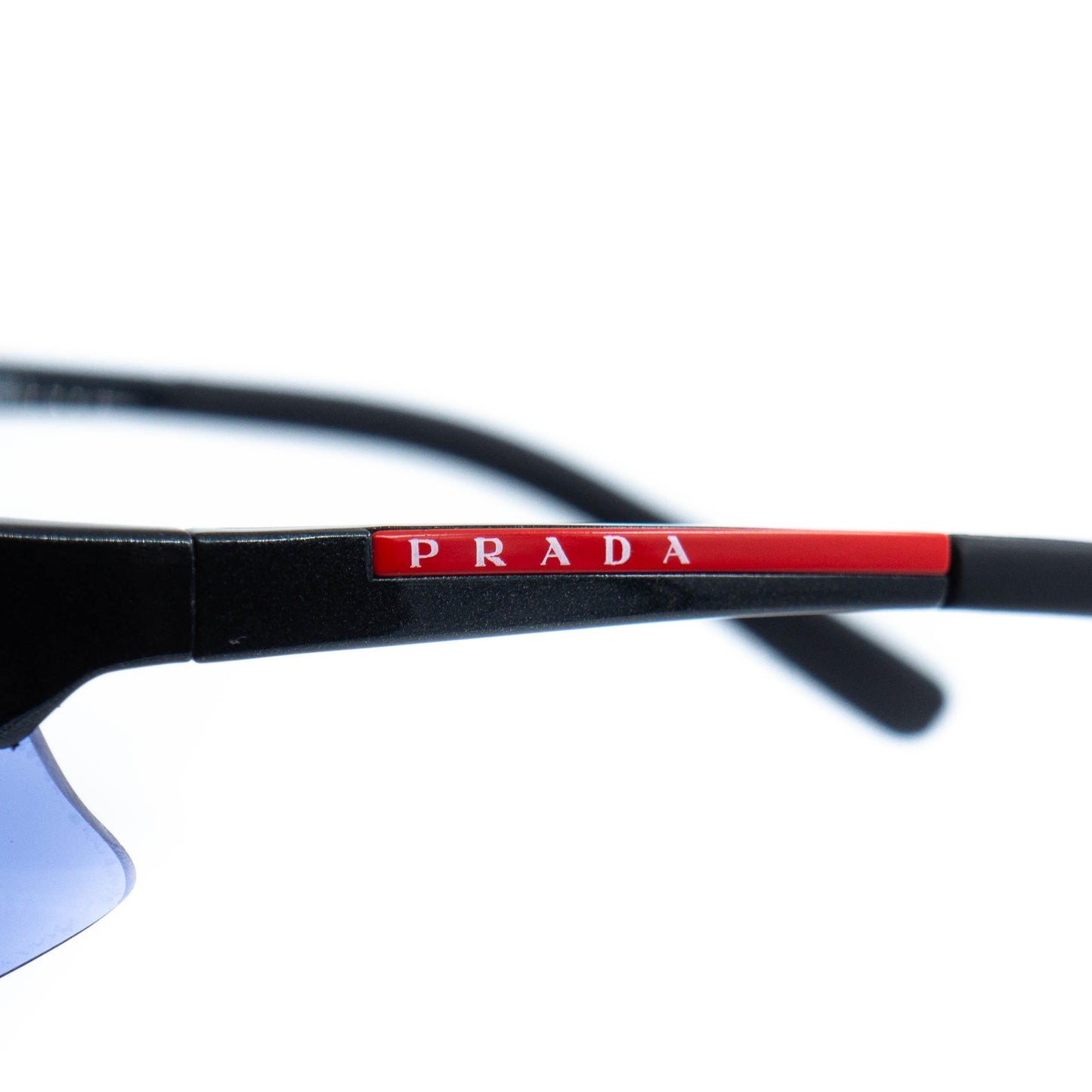 Close-up of Prada red logo on temple