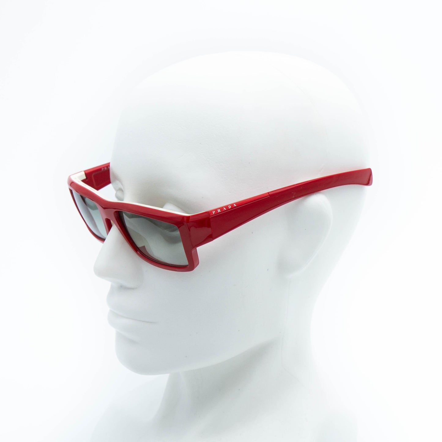 Prada red frame sunglasses on mannequin
