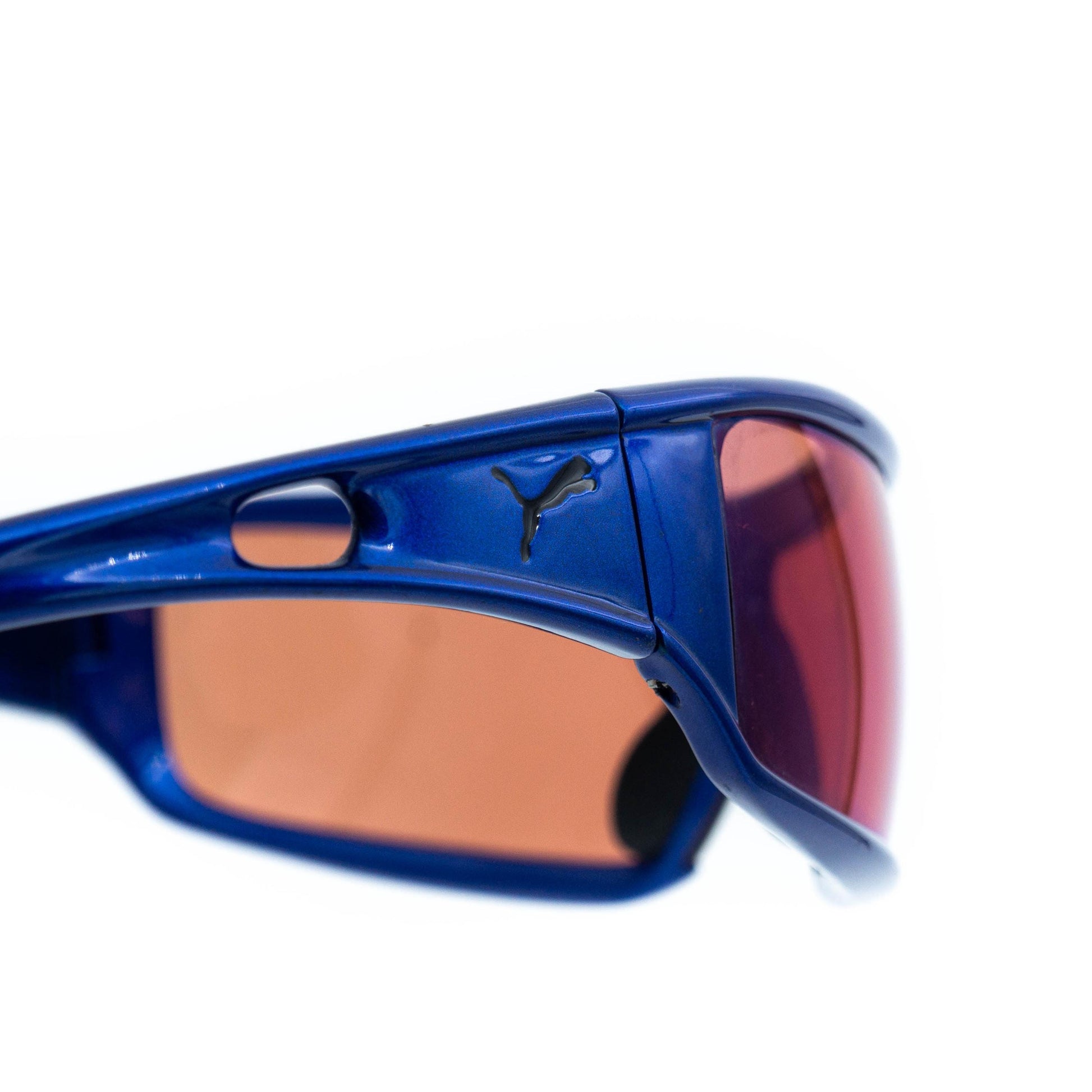 Puma sport sunglasses with pink lenses close-up