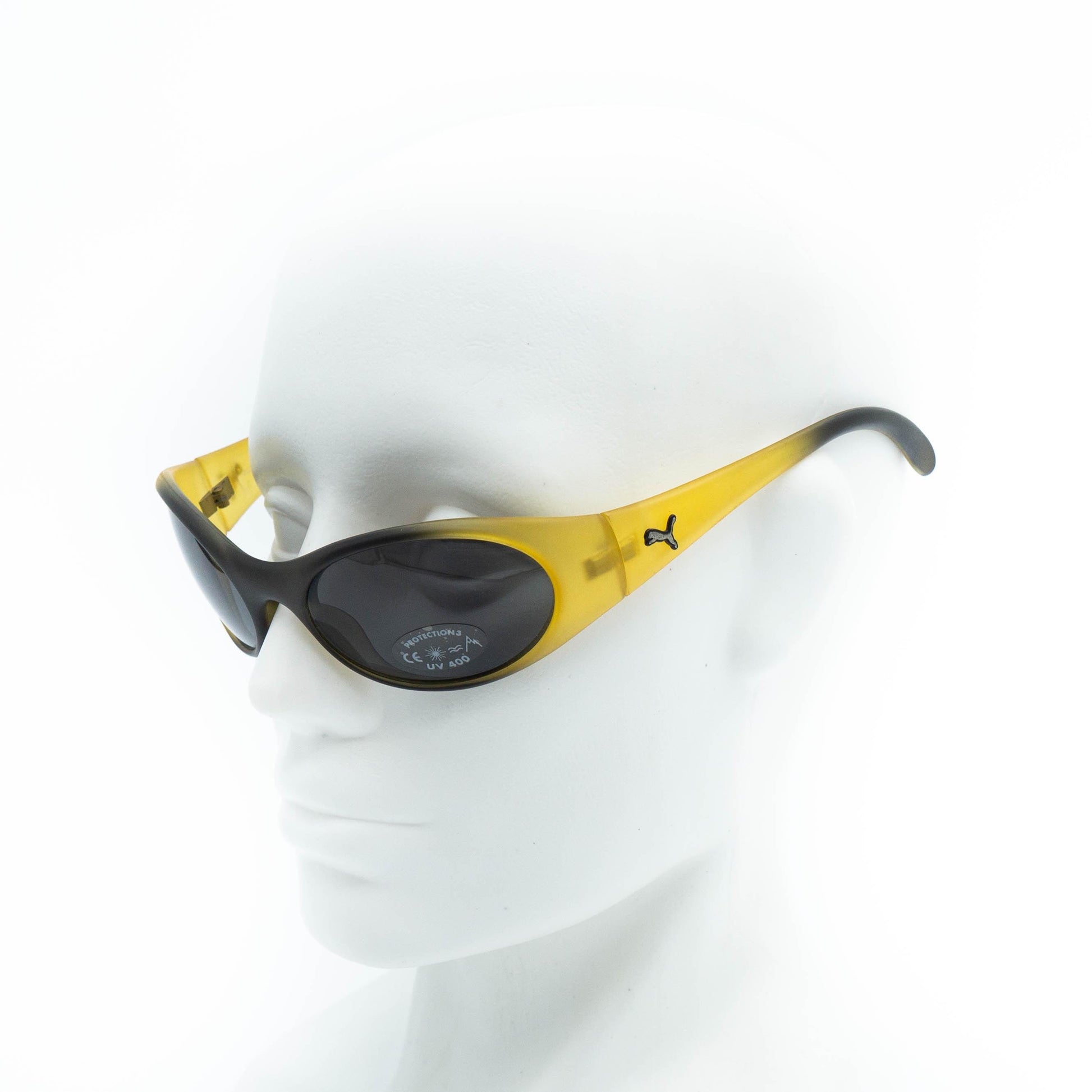 PUMA yellow oval sunglasses on mannequin side view