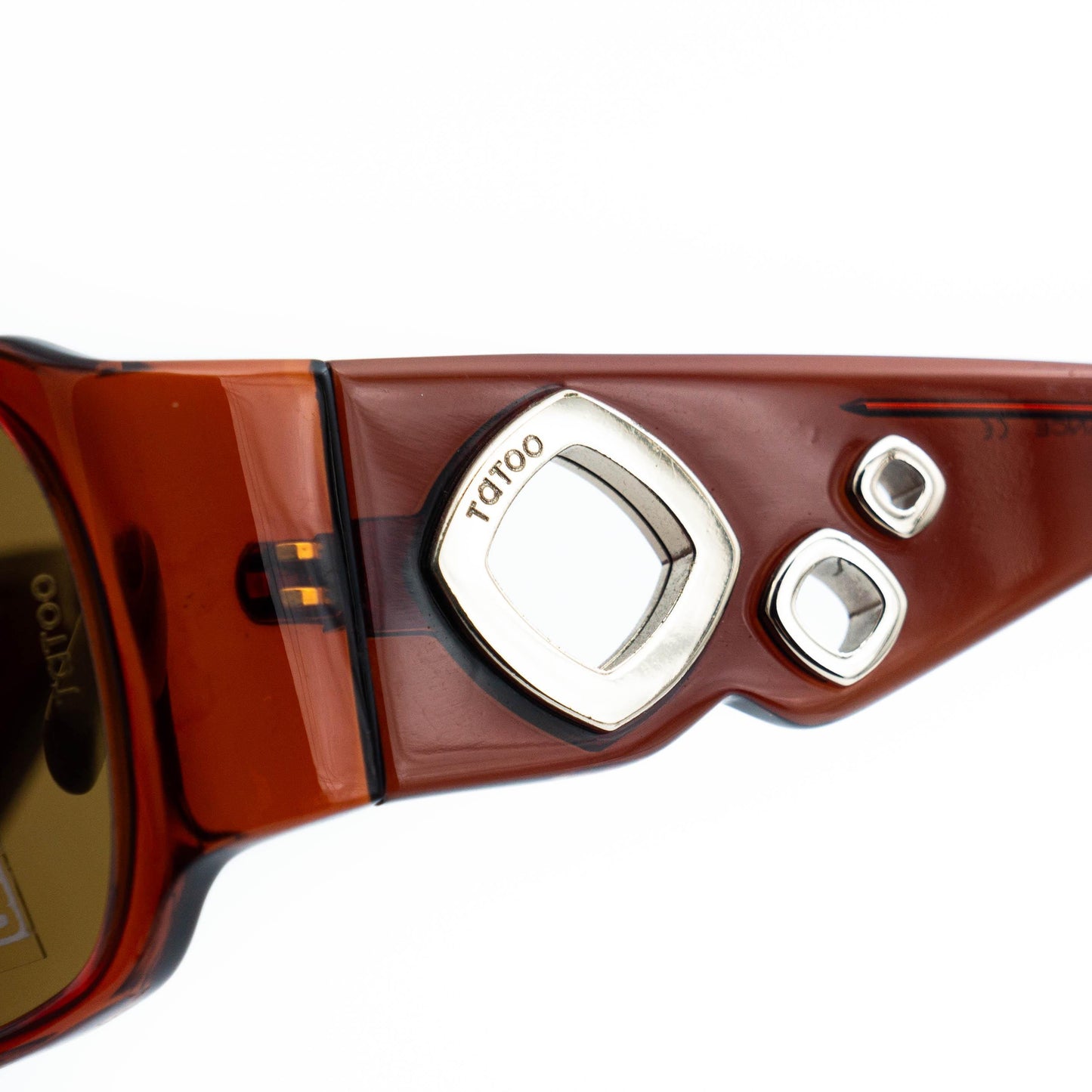 Close-up of MOREL Tatoo metallic circle temple design