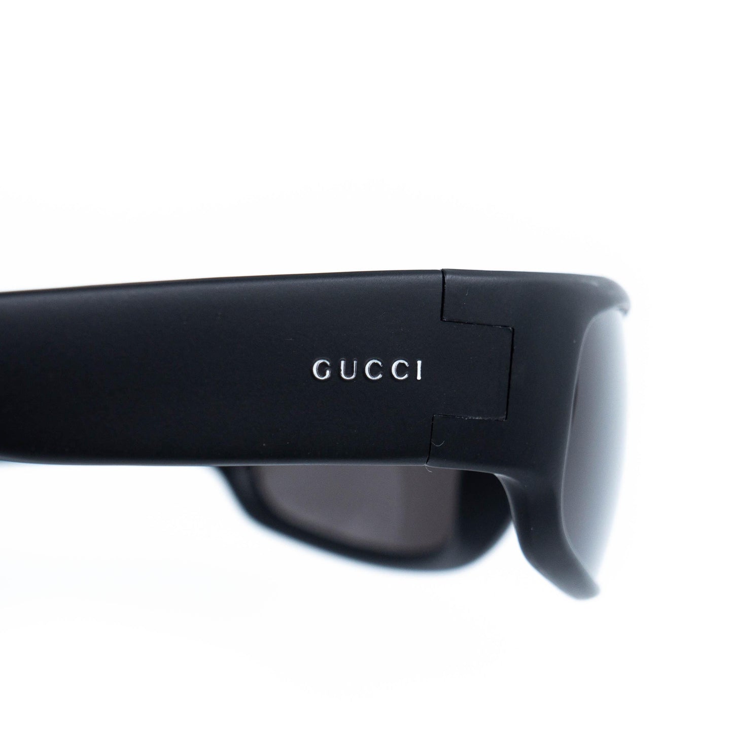 Close-up of Gucci logo on wide temple