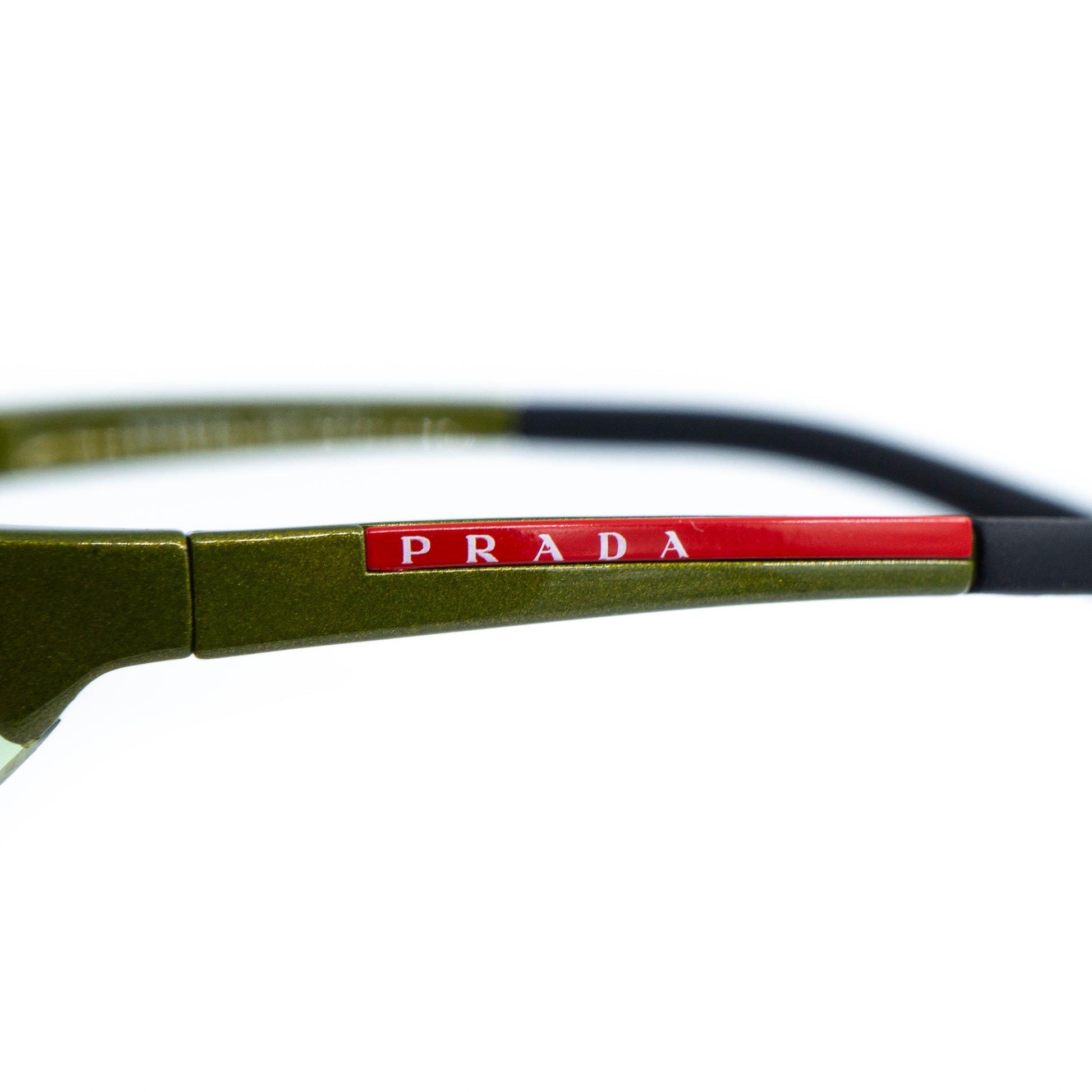 Close-up of red Prada logo on temple